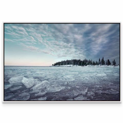 a picture of a frozen lake with trees in the background