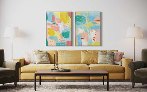 a living room with two paintings on the wall