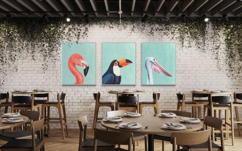 a restaurant with a brick wall and three paintings of birds on the wall