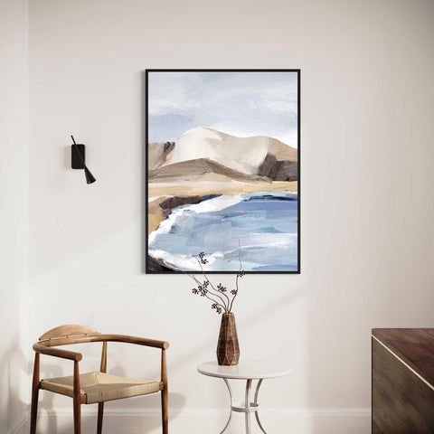 a painting hanging on a wall next to a chair