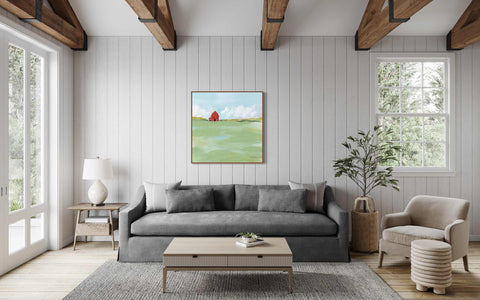 a living room filled with furniture and a painting on the wall