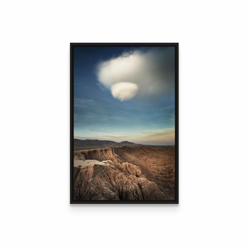 a picture of a desert landscape with a cloud in the sky