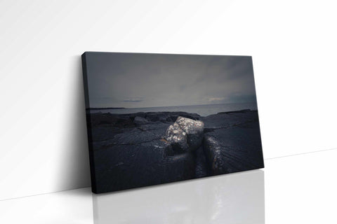 a black and white photo of a rocky beach