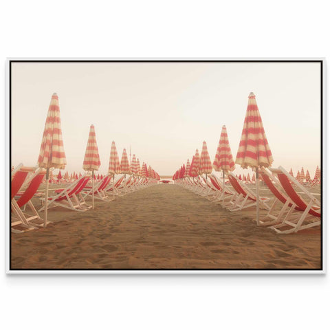 a row of beach chairs sitting on top of a sandy beach