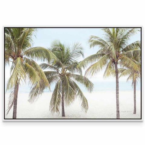 three palm trees on a beach with the ocean in the background