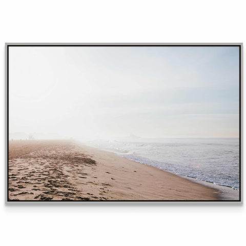 a picture of a beach with footprints in the sand