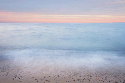 a blurry photo of the ocean at sunset