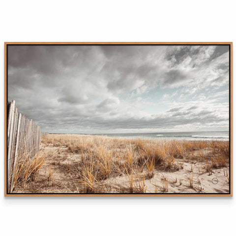 a picture of a beach with a wooden fence