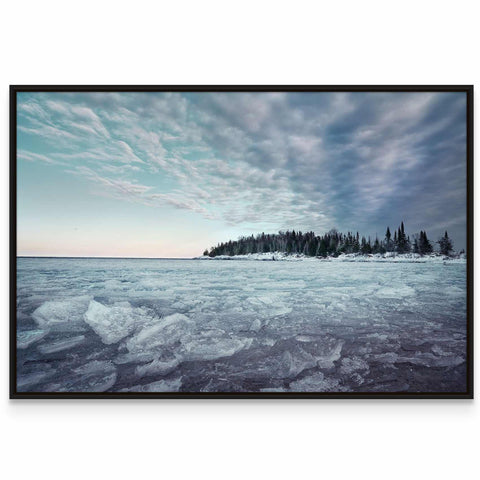 a picture of a frozen lake with trees in the background