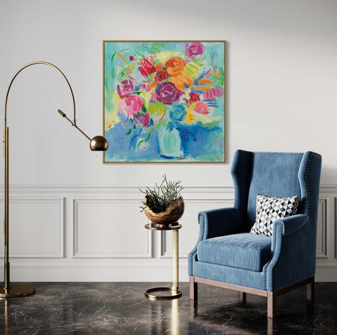 a blue chair in a room with a painting on the wall