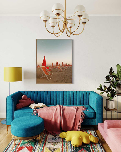 a living room with a blue couch and a painting on the wall