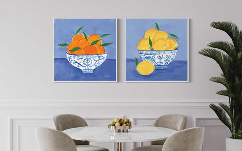 two paintings of oranges in a bowl on a wall