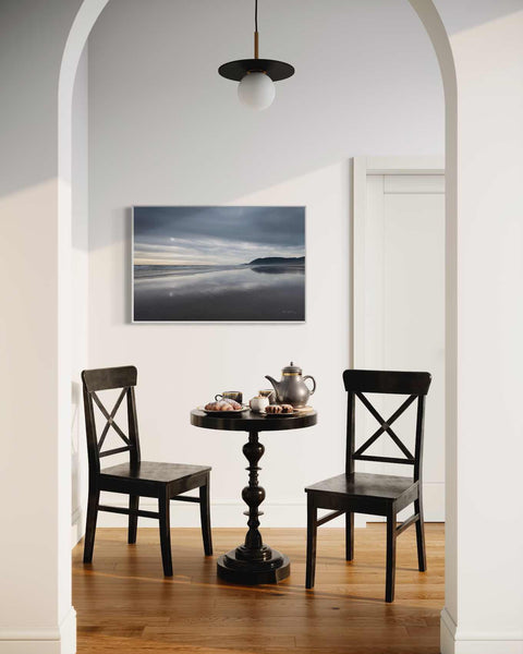 a table with two chairs and a tea pot on it