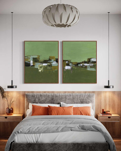 a bedroom with a large bed and two paintings on the wall