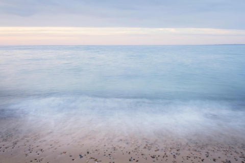 a beach with a body of water in the distance