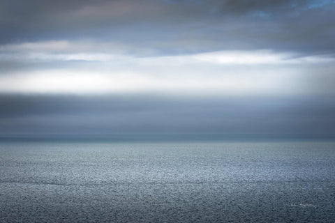 a large body of water under a cloudy sky