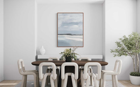 a dining room table with white chairs and a painting on the wall