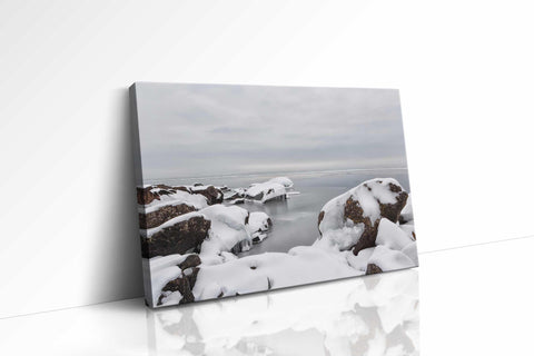 a picture of a rocky beach covered in snow