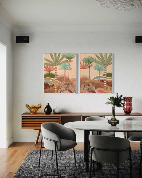 a dining room with two paintings on the wall
