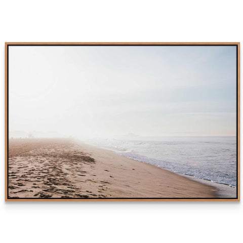 a picture of a beach with footprints in the sand