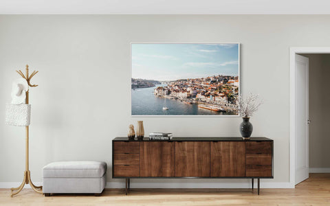 a living room with a picture hanging on the wall