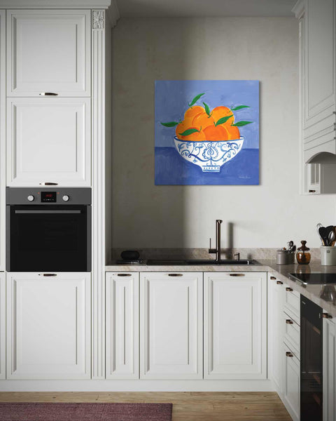 a painting of oranges in a bowl on a kitchen wall