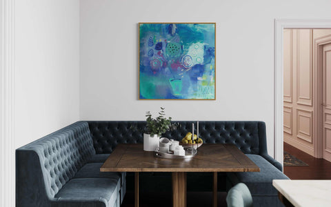 a painting hangs on the wall above a table