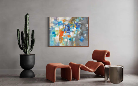 a painting hanging on a wall next to two chairs