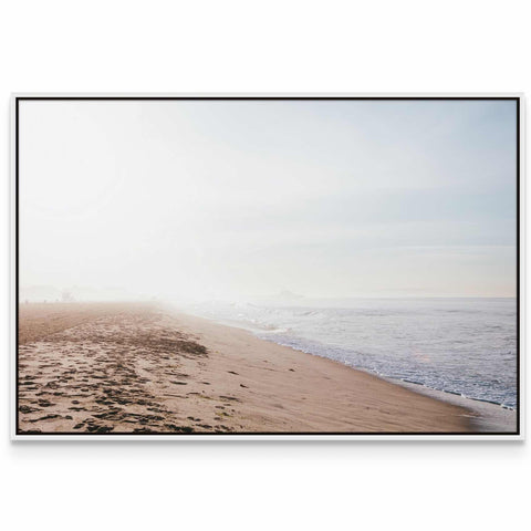 a picture of a beach with footprints in the sand