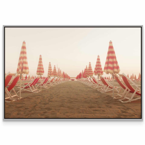 a row of beach chairs sitting on top of a sandy beach