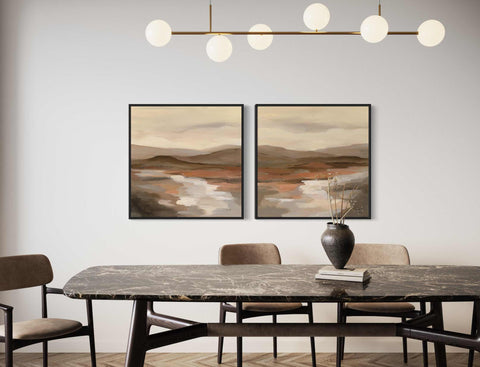 a dining room with two paintings on the wall