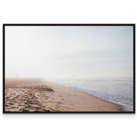 a picture of a beach with footprints in the sand