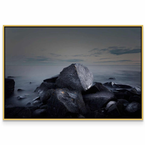 a black and white photo of rocks and water