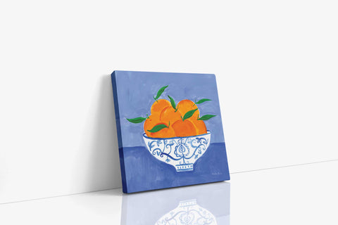 a painting of oranges in a blue and white bowl