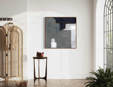 a white room with a gold stand and a painting on the wall
