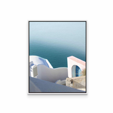 a picture of a white building with blue water in the background
