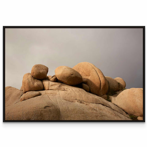 a picture of a rock formation with a cloudy sky in the background