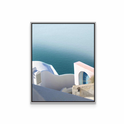 a picture of a white building with blue water in the background