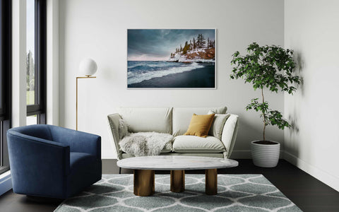 a living room filled with furniture and a painting on the wall