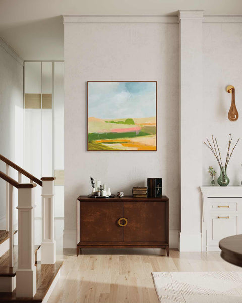 a living room with a painting on the wall