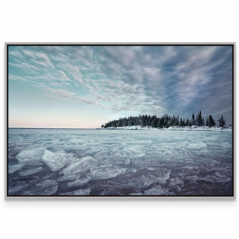 a picture of a frozen lake with trees in the background