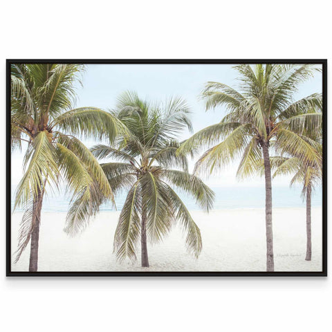 three palm trees on a beach with the ocean in the background