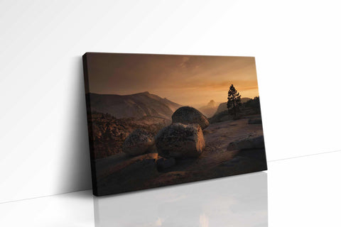 a picture of a rocky landscape with a sunset in the background