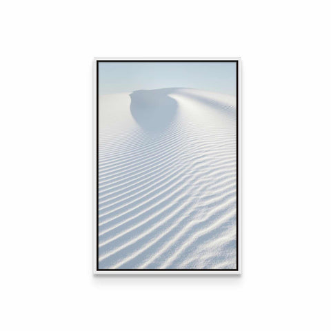 a framed photograph of a sand dune