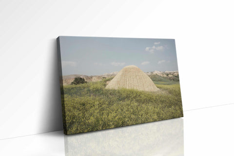 a large mound of hay sitting in a field