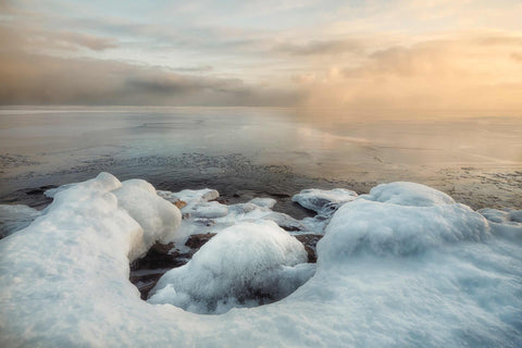 a body of water surrounded by snow and ice