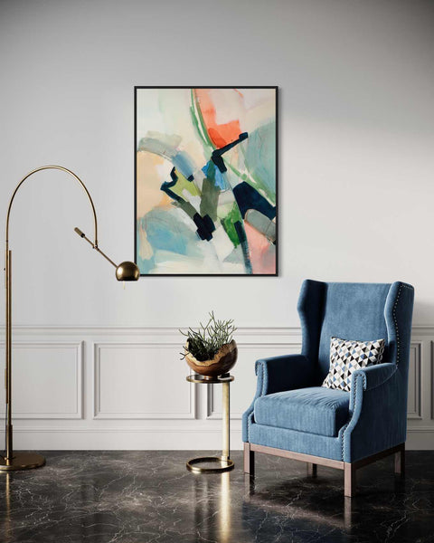 a living room with a blue chair and a painting on the wall
