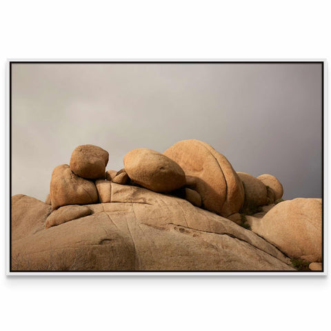 a picture of a rock formation with a cloudy sky in the background