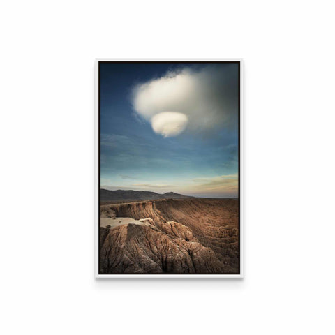 a picture of a mountain range with a cloud in the sky