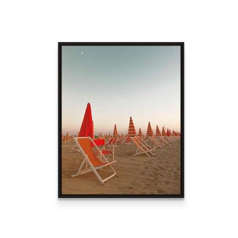 a group of beach chairs sitting on top of a sandy beach